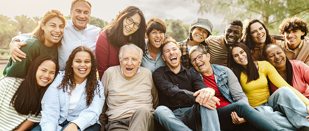 Diverse community of all ages gather for a group photo