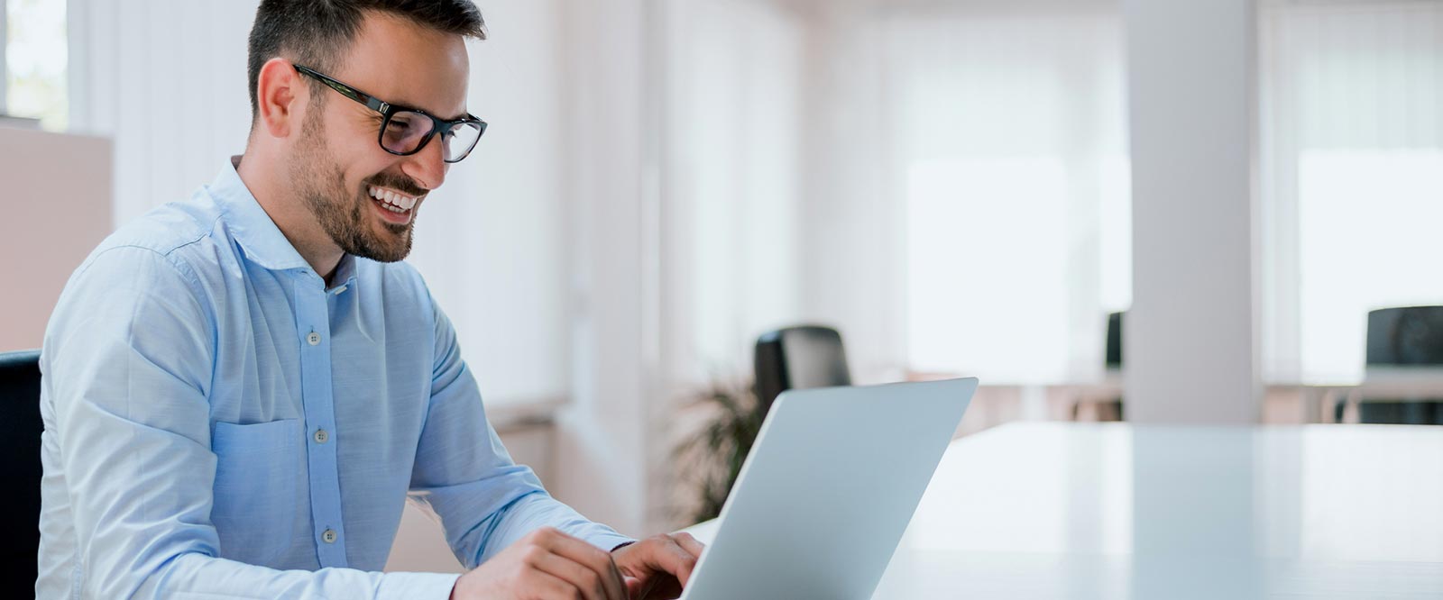 A man working on a laptop computer in an office