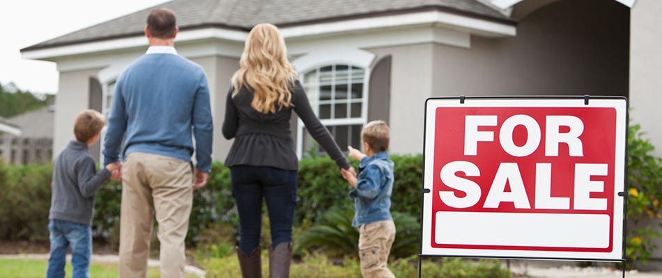 A young family looking at a house that is for sale