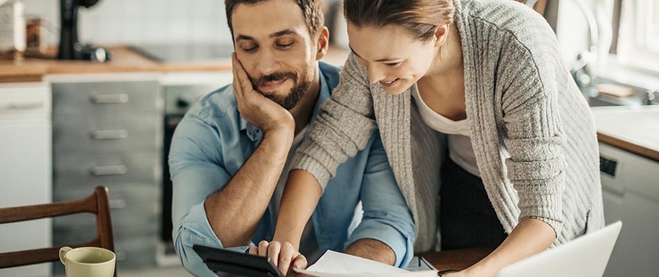 A couple in their home going over finances