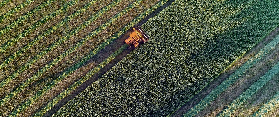 A tractor in operation in a farmfield