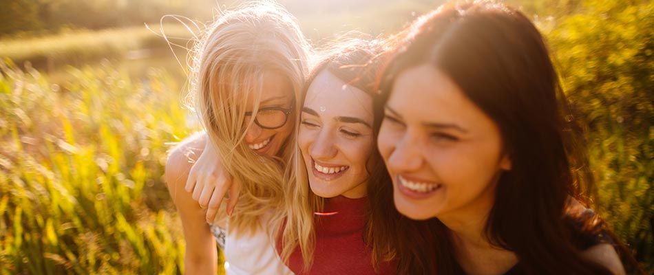 Three young ladies together in a field