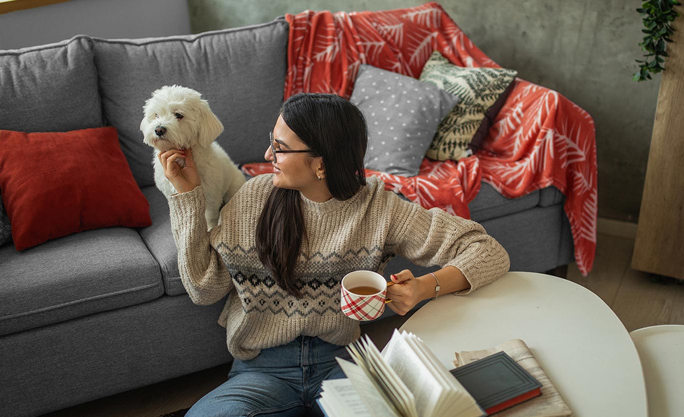 A lady and her dog in a living room