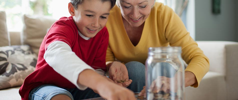 A grandmother and her grandson saving coins