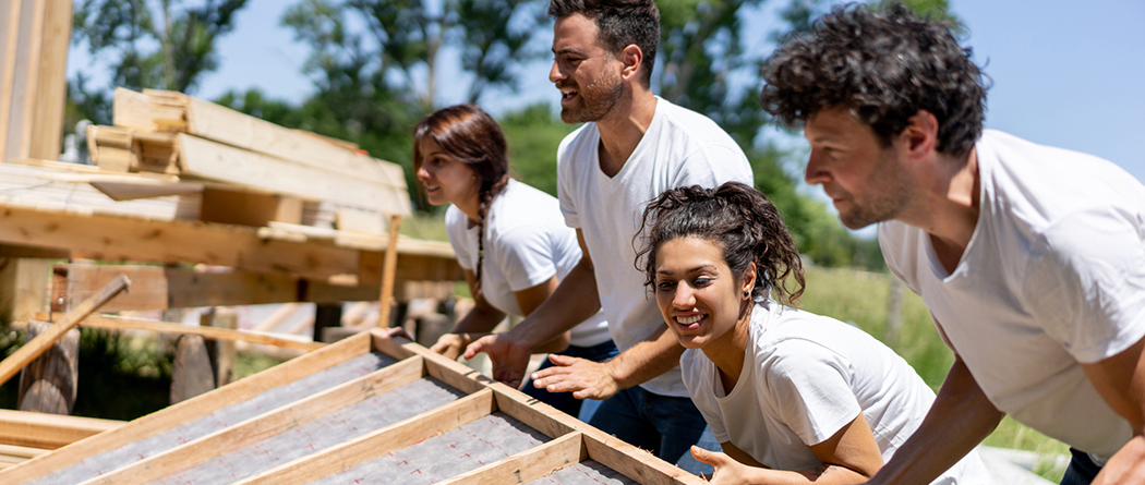 Volunteers work together to build a structure